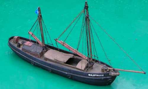 Photo of a model of a small coastal sailing barge
