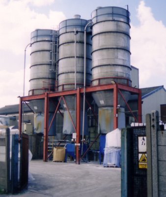 Photo showing set of three storage silos at a plastics factory