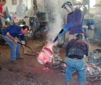 Photo showing Pouring the molten metal into a mould