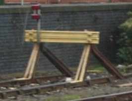 Photo of modern rail-built buffer with yellow painted cross members