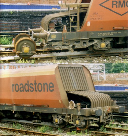 Two photos showing a Modern freight bogie undergoing repairs.